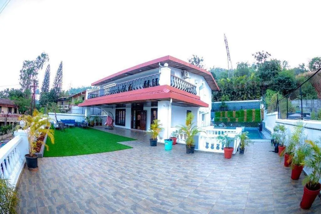 Deck, lawn and pool in daylight — Carpe Diem, Lonavala