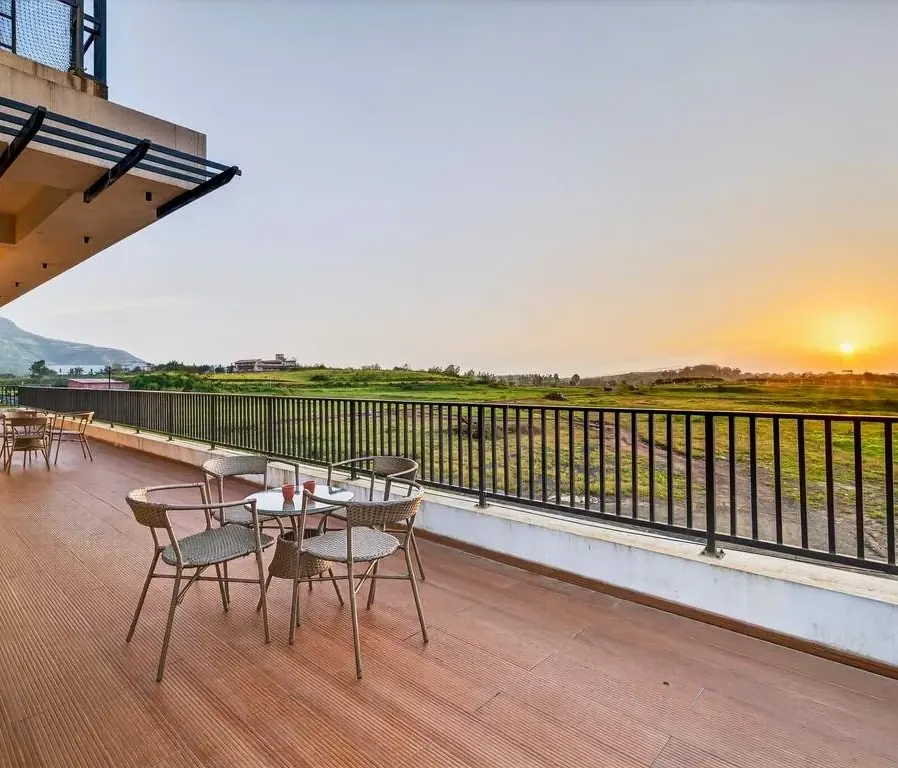 Sunset from the farm-view terrace — Greenwood Villa, Igatpuri