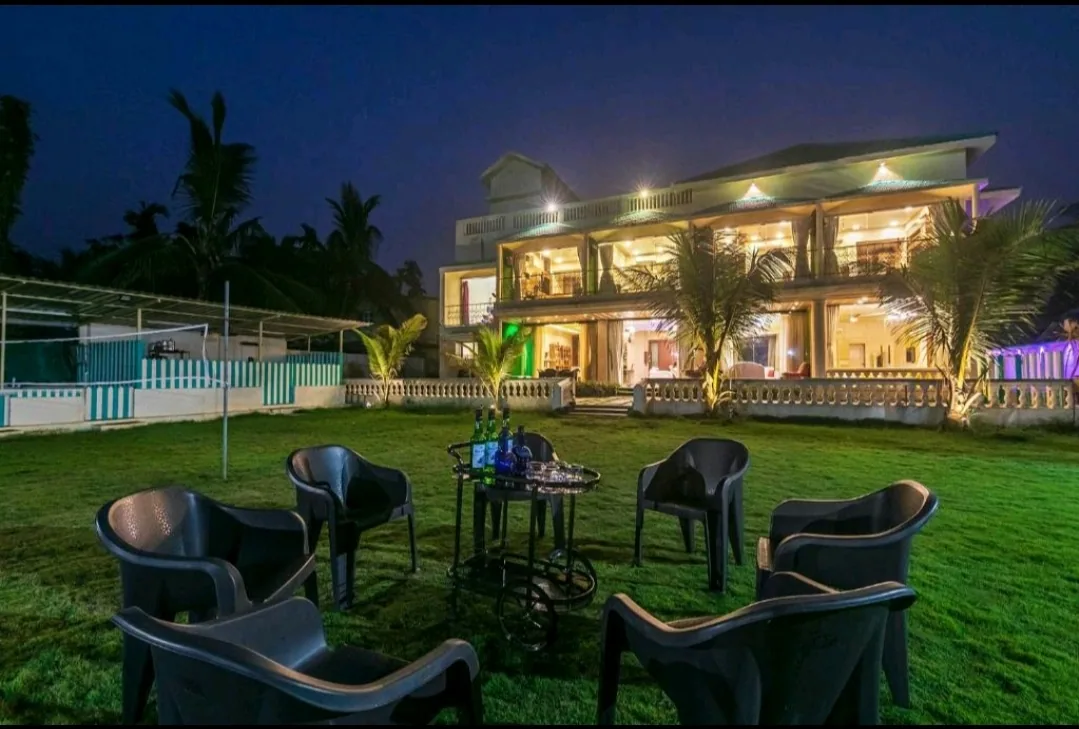 Upper-floor bedroom with balcony access — Heritage Villa, Nagaon Alibaug