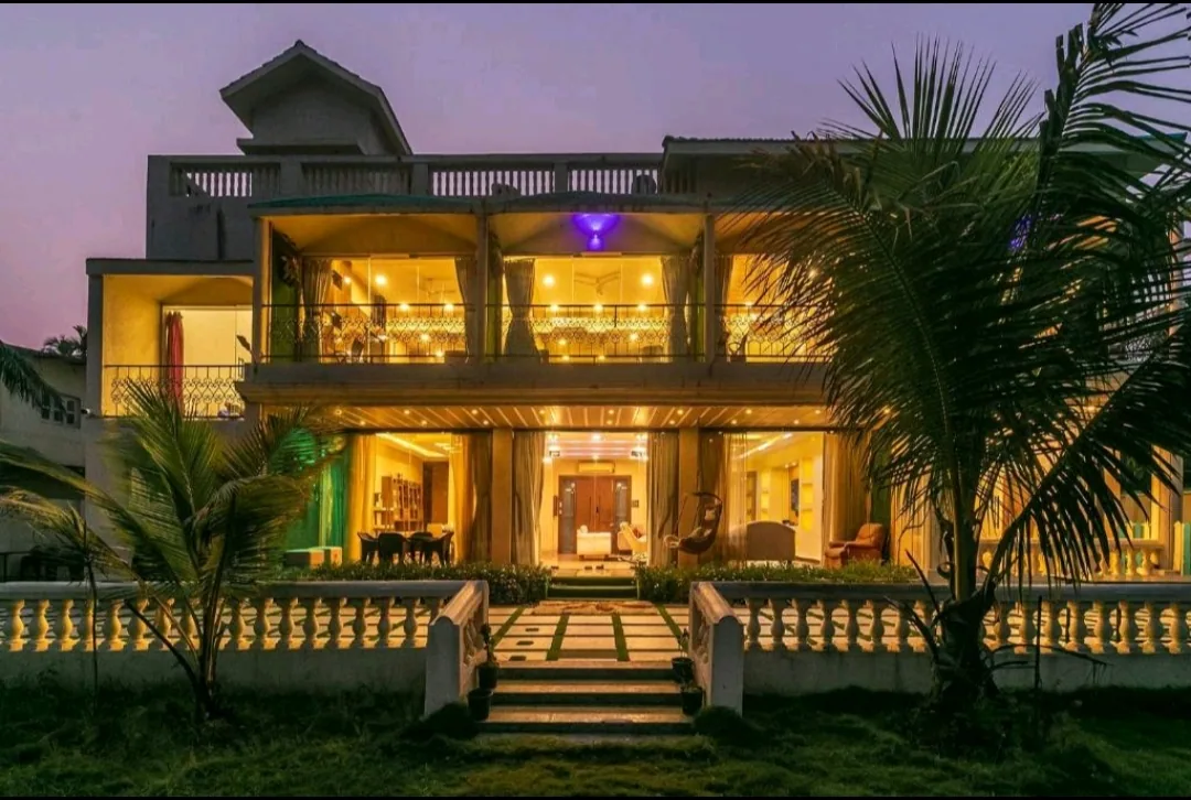 Heritage Villa, Nagaon Alibaug — 5BHK private pool villa lit up at dusk
