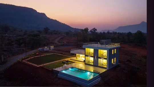 The villa lit up after sunset — Majestic Cascade Villa, Karjat