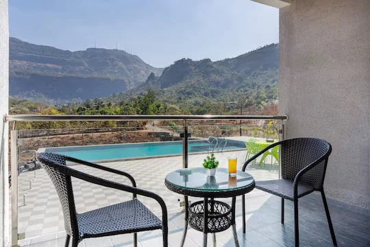 Balcony seating above the pool — Majestic Cascade Villa, Karjat