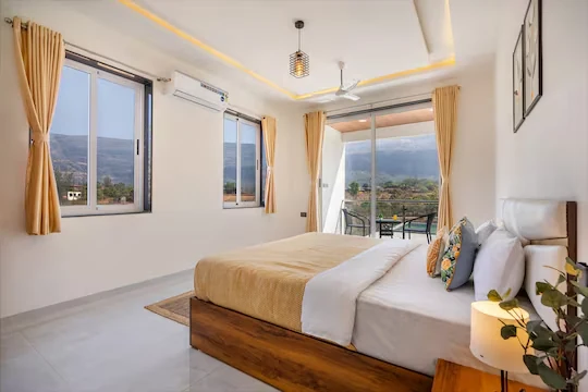 Air-conditioned bedroom with balcony — Majestic Cascade Villa, Karjat