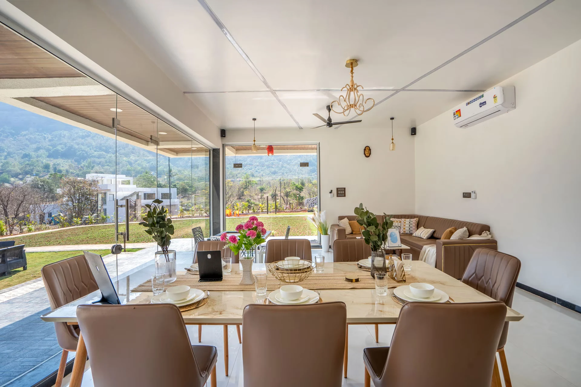 Dining area opening onto the lawn — Majestic Cascade Villa, Karjat
