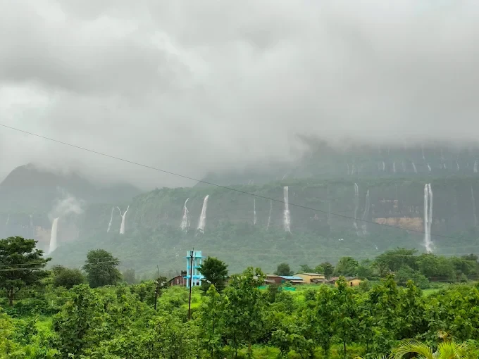Monsoon waterfalls on the facing hillside — Majestic Cascade Villa, Karjat