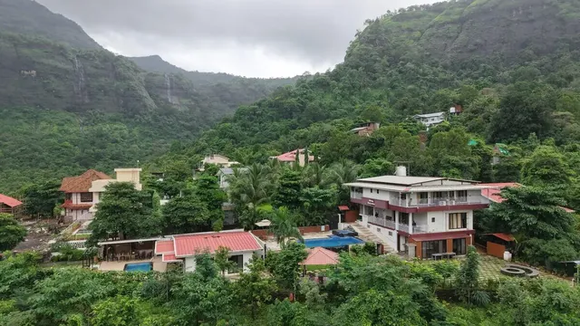 The property from the air, set into the hillside — Misty Cascades, Karjat
