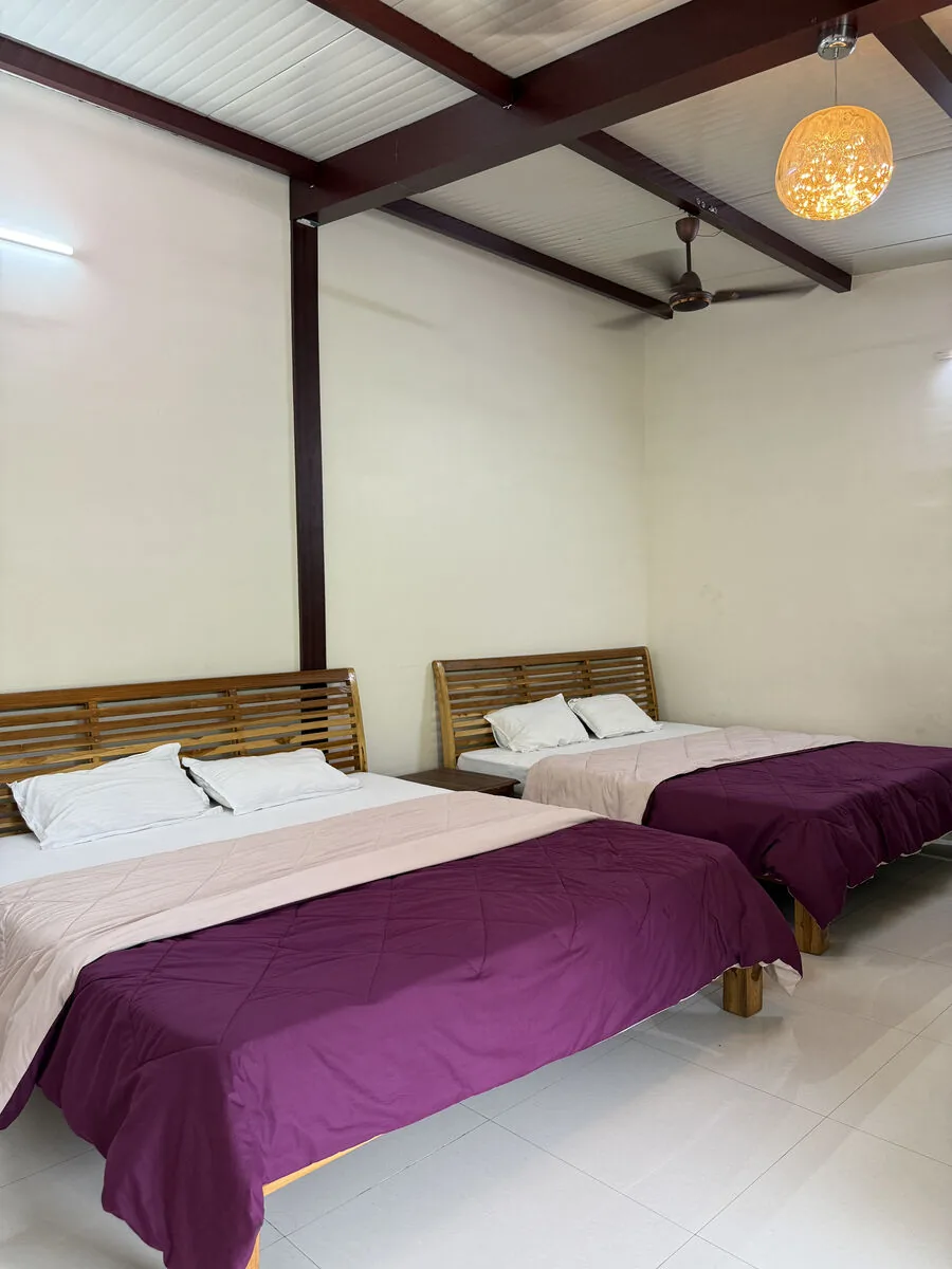Bedroom 2 — two kings with wooden headboards — Misty Cascades, Karjat