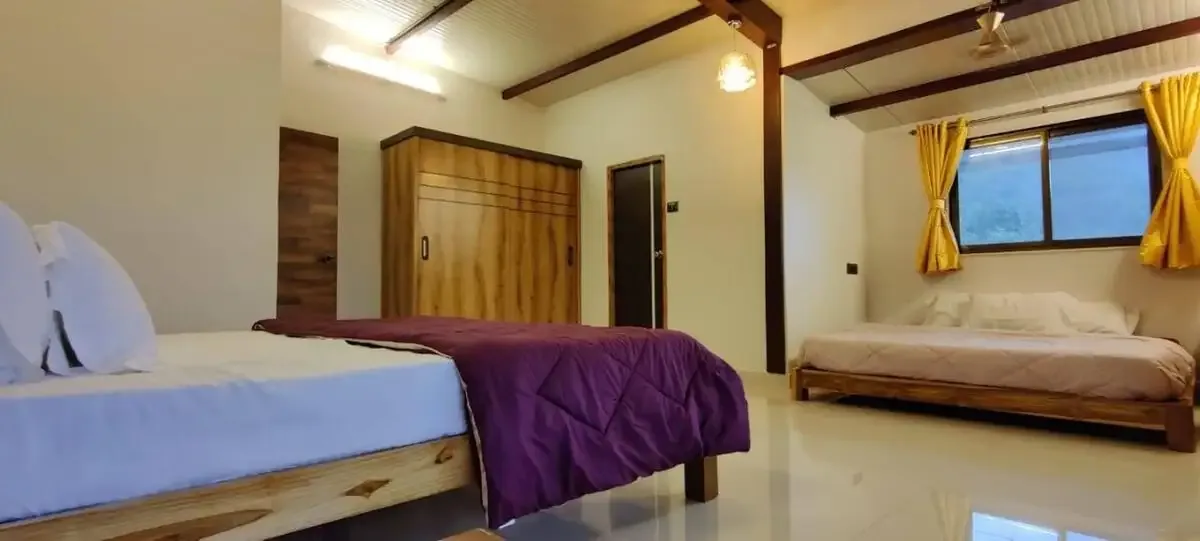 Bedroom with a wardrobe and an extra bed — Misty Cascades, Karjat