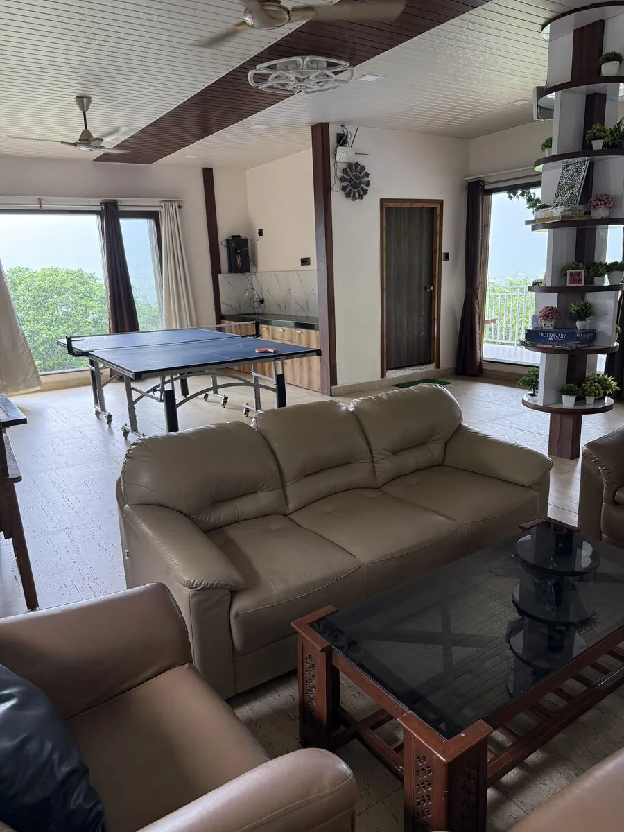 Seating in the hall, with the table-tennis table behind — Misty Cascades, Karjat