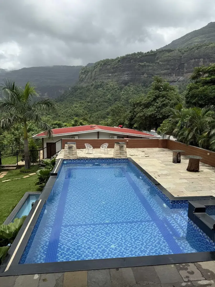 The pool and deck seen from the upper level — Misty Cascades, Karjat
